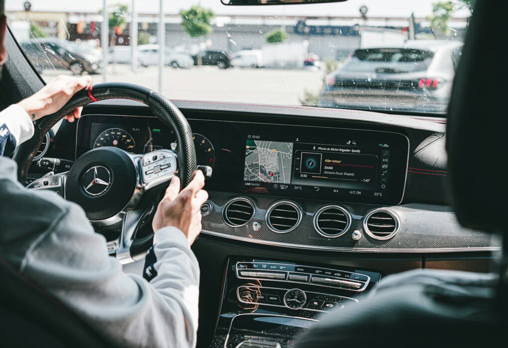 person in gray long sleeve shirt driving car