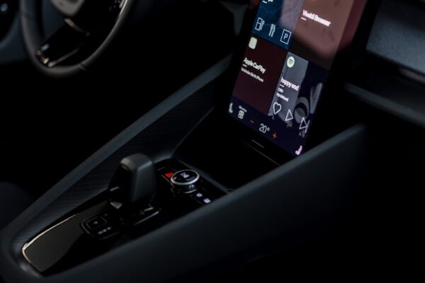 a car dashboard with a cell phone in the center