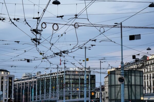 a street with buildings and wires above it